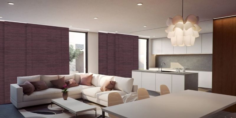 A living room area has large sliding glass doors with panel track shades.