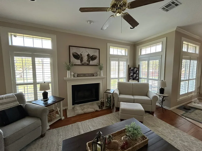 Plantation shutters beside a fireplace in a Texas living room