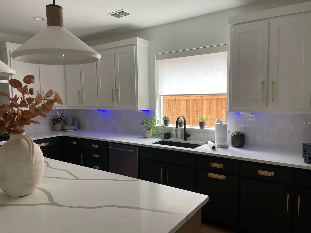 Roller shade over a kitchen sink window in a Texas home